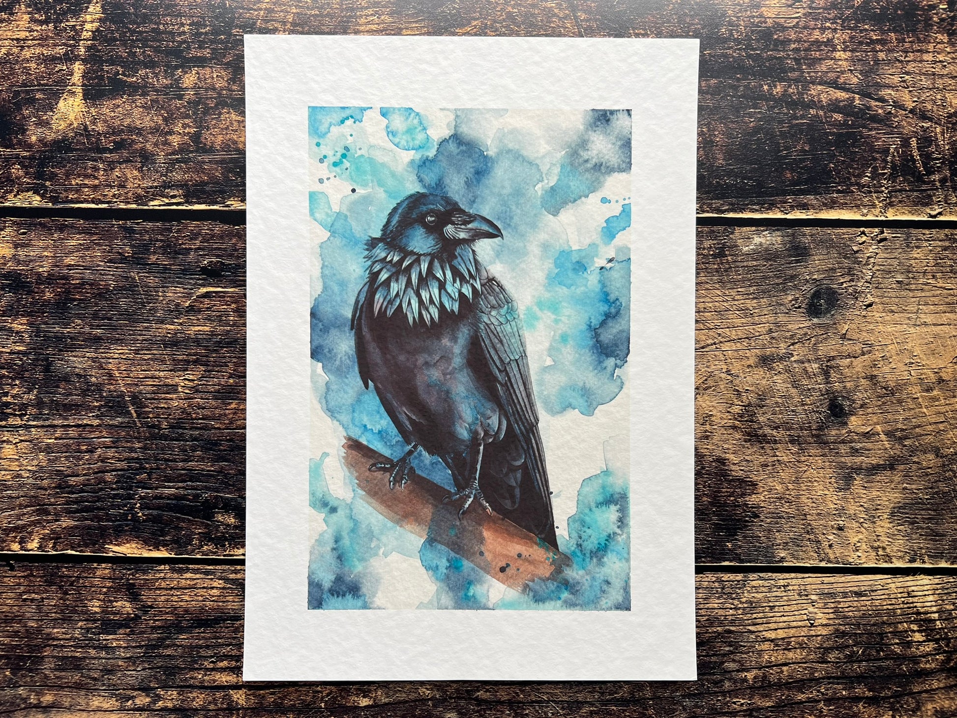 A watercolour print of a raven