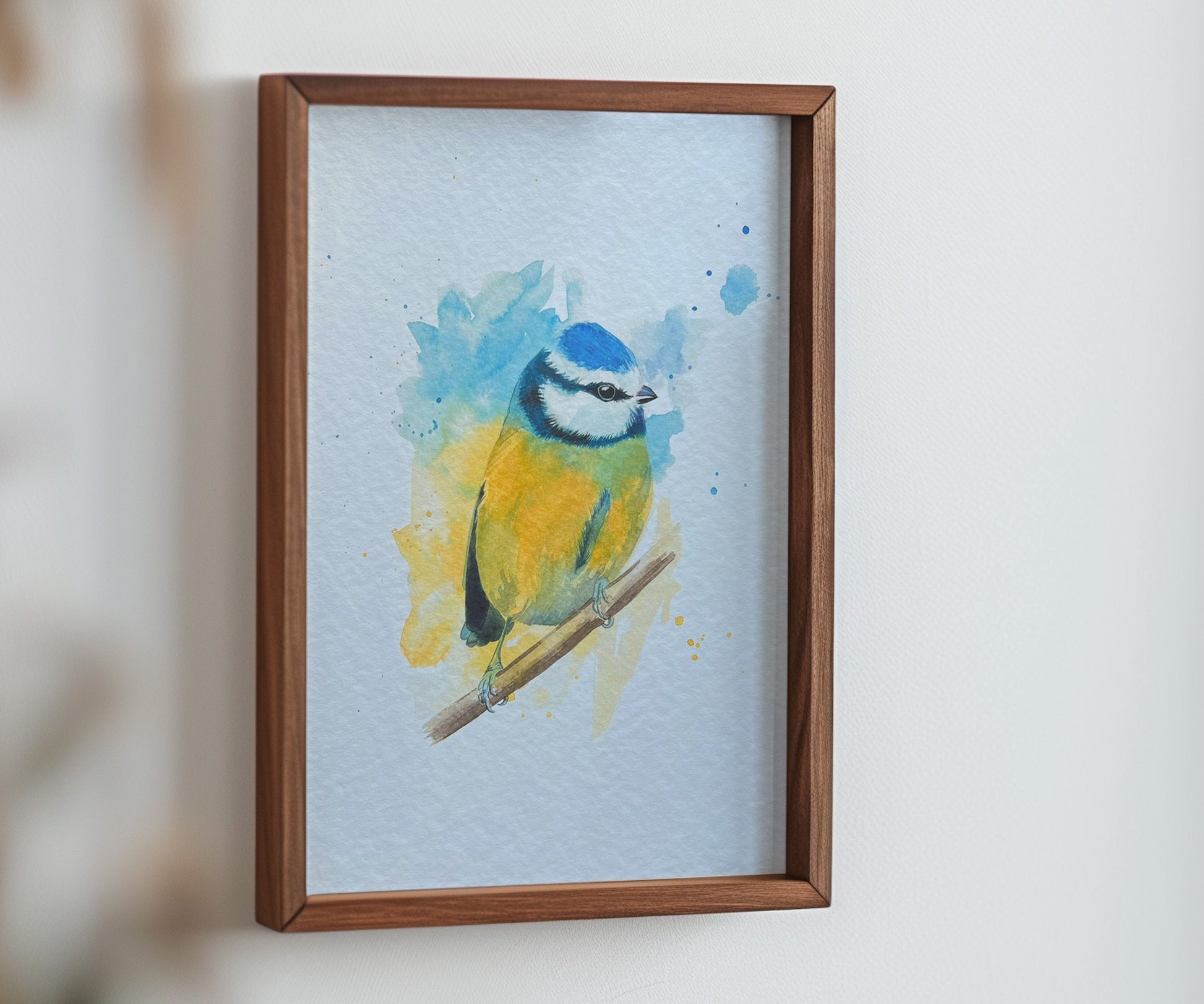 An A4 print of a blue tit on textured archival paper in a wooden frame.