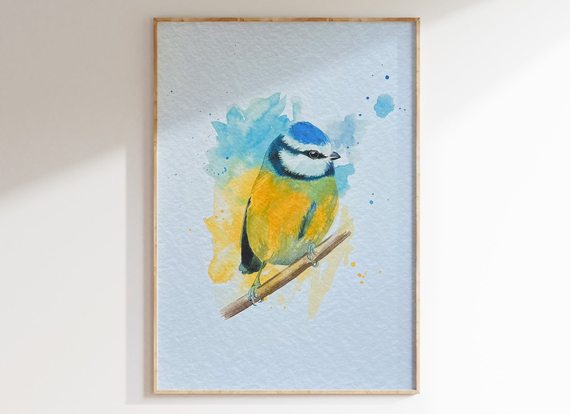 An A4 print of a blue tit on textured archival paper in a wooden frame.