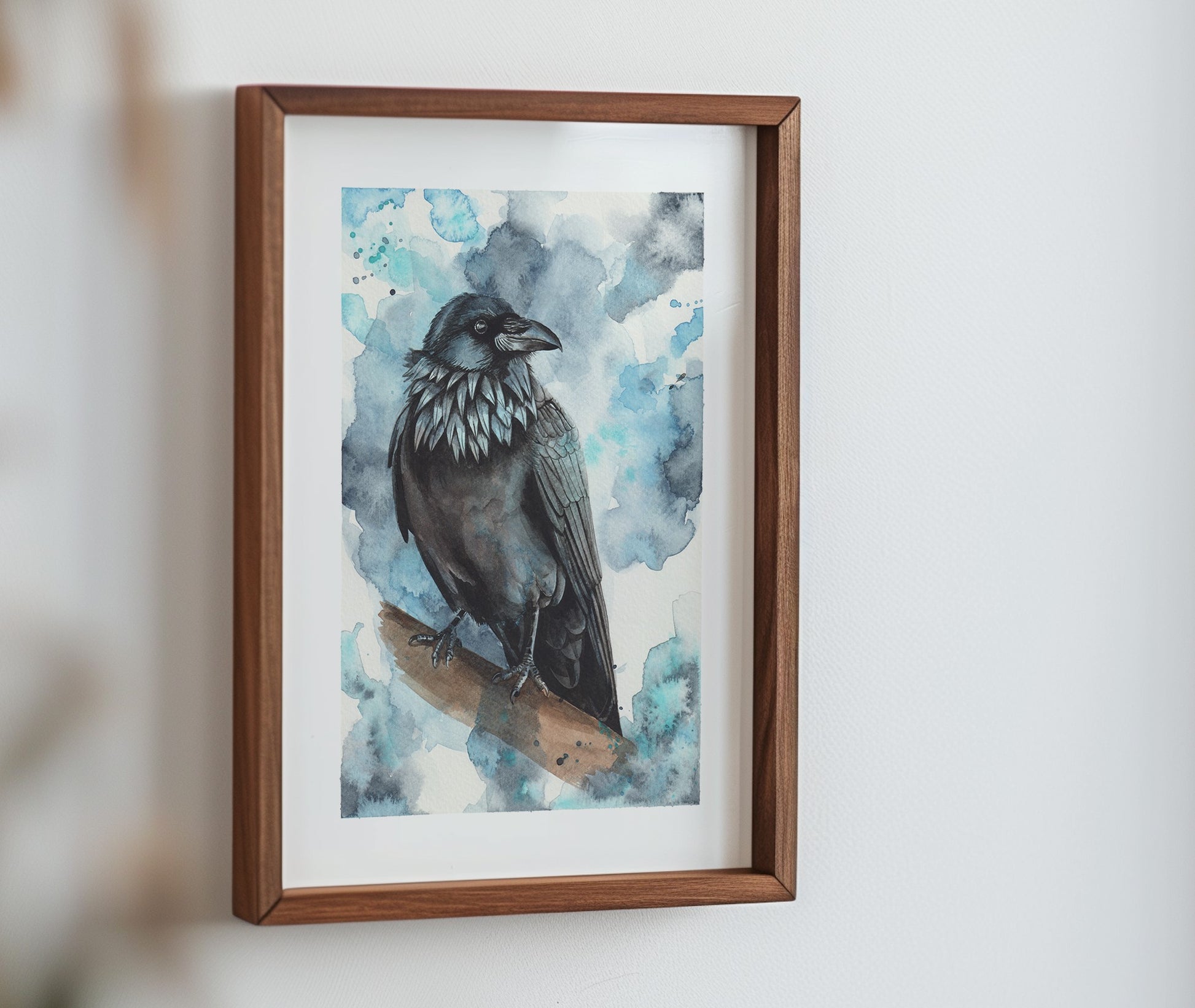 A watercolour print of a raven, mocked up into a frame